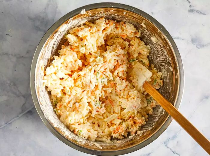 An overhead view of the potato casserole mixture in a bowl.