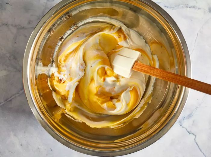 A top-down view of the sour cream and condensed soup mixture in a bowl.