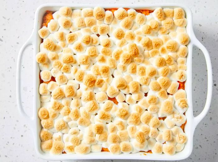 Mashed sweet potatoes baked to perfection with golden-brown marshmallows on top.