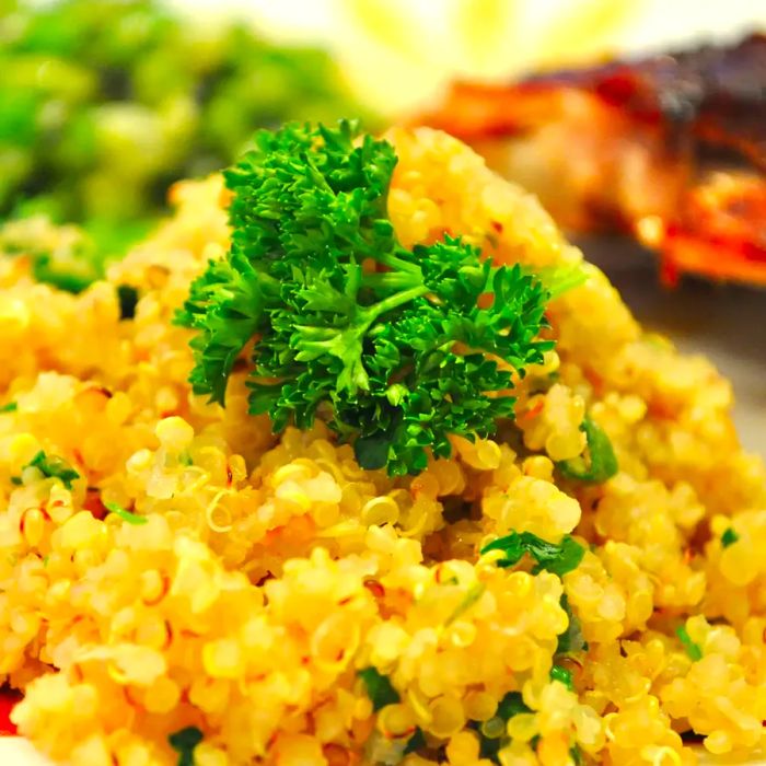 A close-up shot of a Quinoa Side Dish topped with fresh herbs.