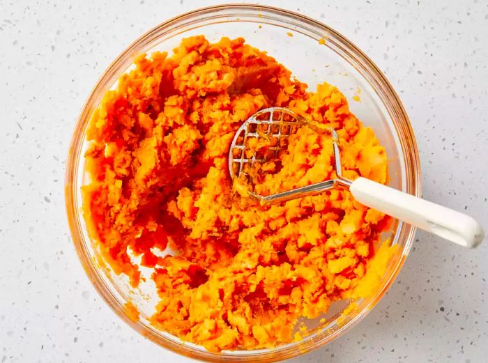 Sweet potatoes mashed and flavored with brown sugar and spices, perfectly blended together.