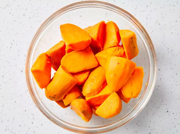 Once the sweet potatoes are dried, transfer them to a mixing bowl.