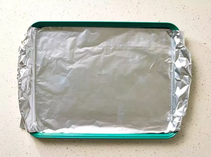 A baking sheet, covered with a layer of aluminum foil