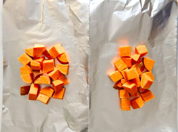 Diced sweet potatoes placed on aluminum foil.