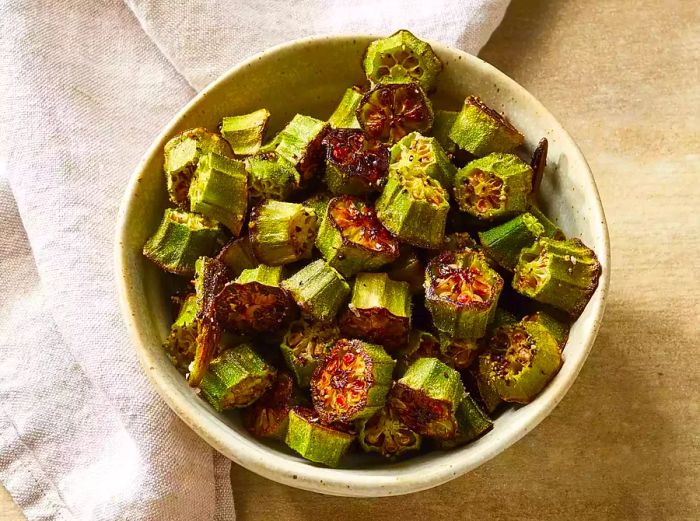 A bowl of roasted okra paired with a tea towel