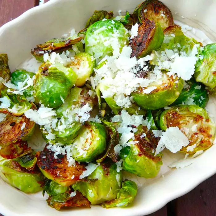 Close-up of Parmesan-coated Brussels sprouts served in a white bowl