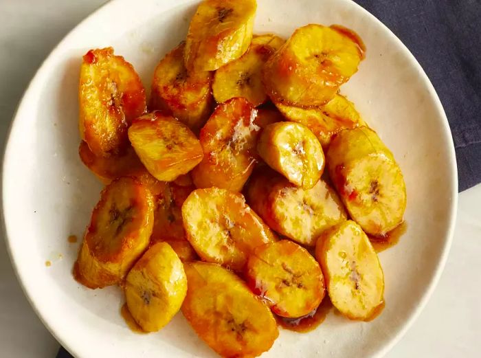 Gazing at a bowl of sliced, sautéed sweet plantains