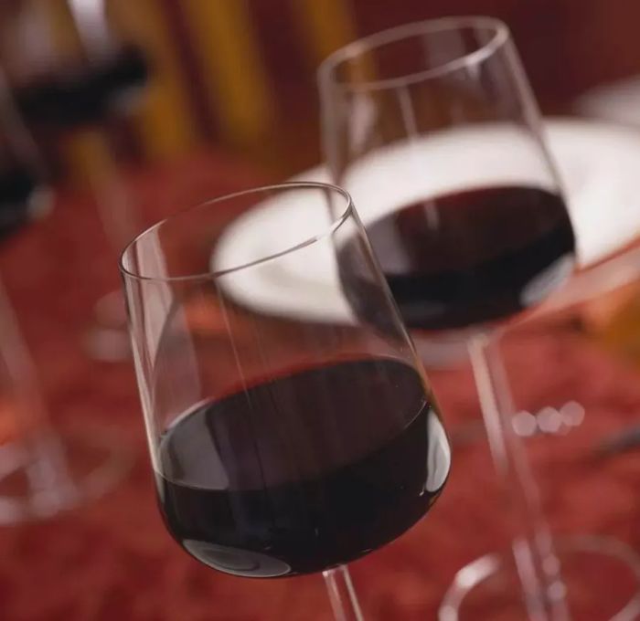 Red wine glasses set on a table.