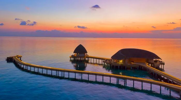 Luxurious beach villas and overwater villas provide elegant accommodations for guests at the exclusive Emerald Faarufushi.