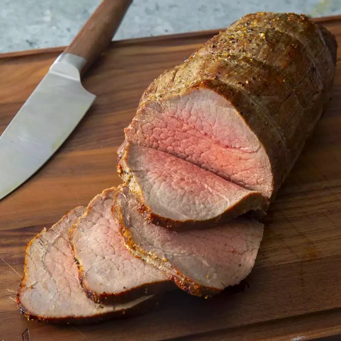 A high-angle shot of roast beef sliced on a cutting board