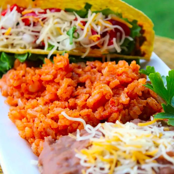 tacos, rice, and beans served on a platter