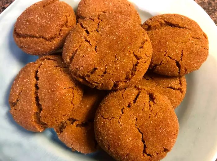 A plate of gingersnaps with a crackling, sugar-topped surface