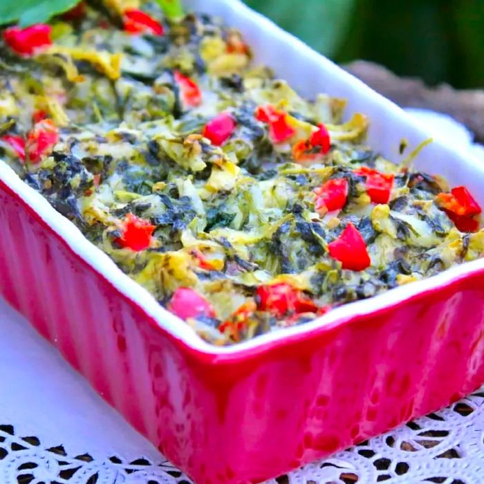 Spinach dip served in a red dish