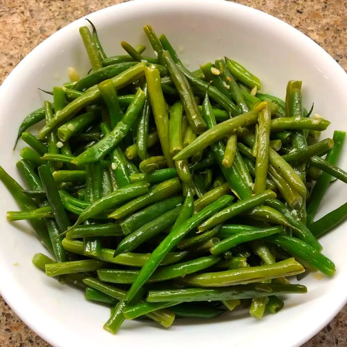 Buttery Garlic Green Beans served in a white bowl