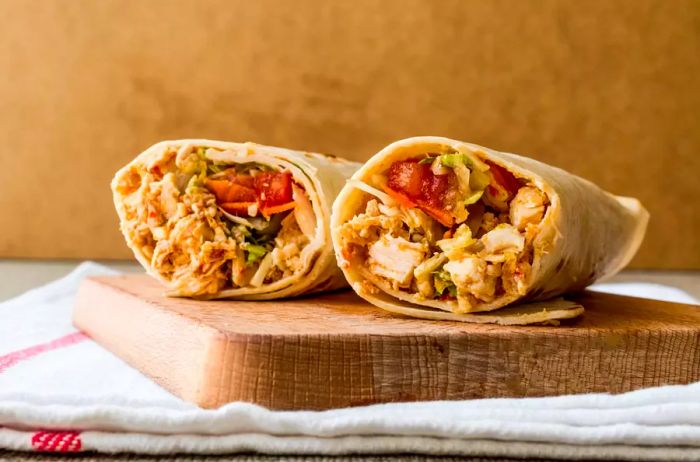 A photo of a chicken shawarma durum wrap, showcasing the savory doner kebab style, with plenty of space for text.