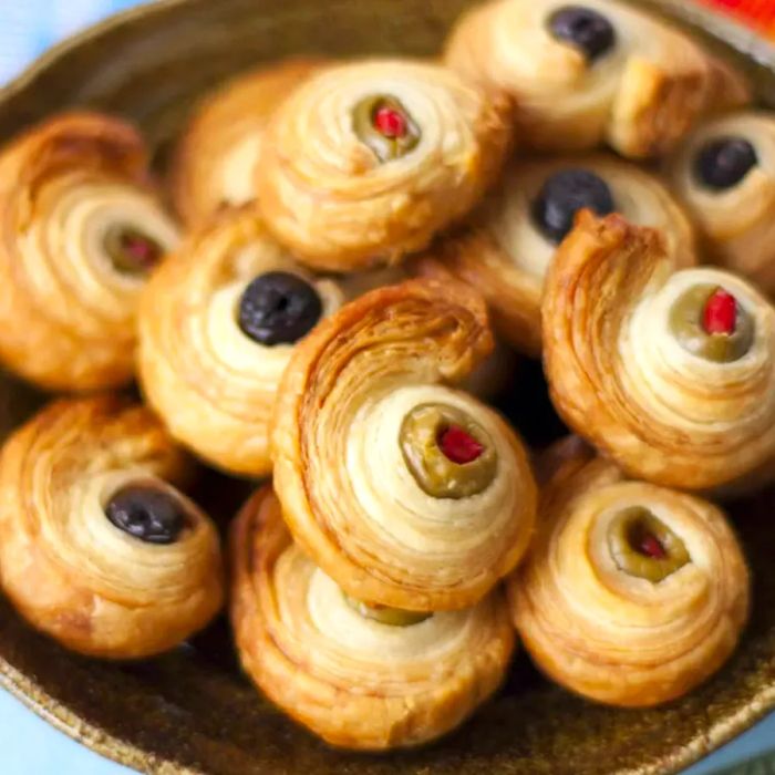 Olives wrapped in puff pastry on a plate