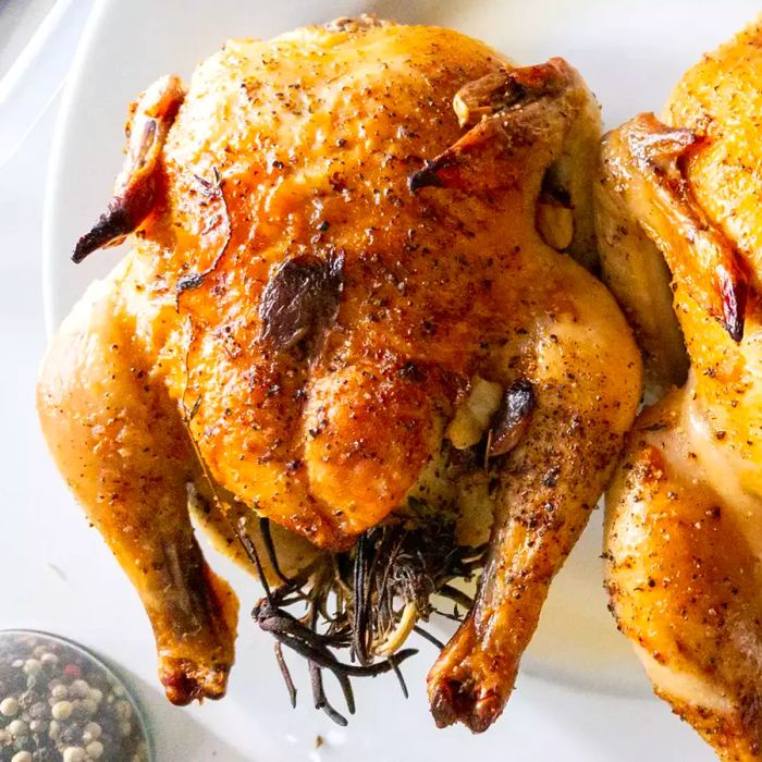 Overhead view of Cornish Game Hens with Garlic and Rosemary on a platter