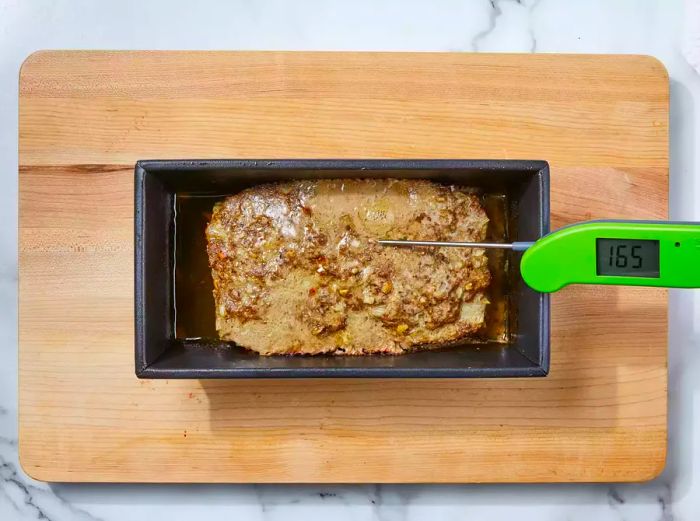 The stuffing meatloaf is baked until the internal temperature hits at least 165°F.