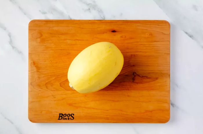 Whole spaghetti squash on a cutting board