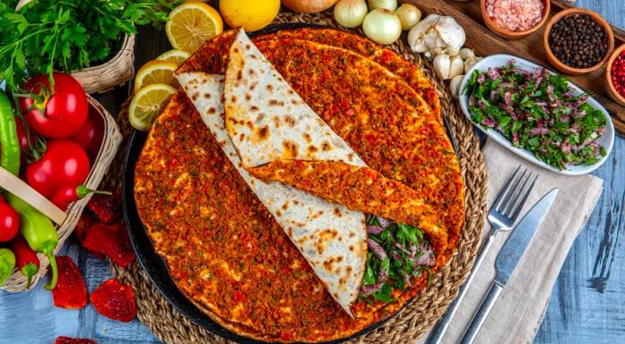 Lahmacun is often dubbed 'Turkish pizza' due to its resemblance to a thin, crispy flatbread topped with savory ingredients.