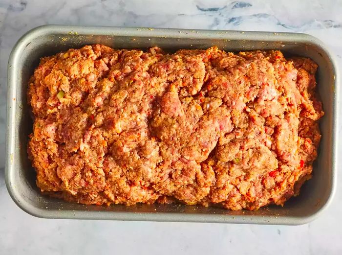 An overhead shot of the meatloaf placed in a baking pan, ready to go in the oven.