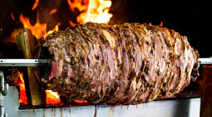 To make this dish, marinated lamb is roasted on a horizontal rotating spit, slowly cooked over a wood fire.