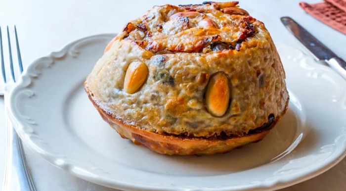 Perde Pilav is a rich dish made with buttery dough filled with rice, chicken, currants, almonds, pine nuts, and butter.