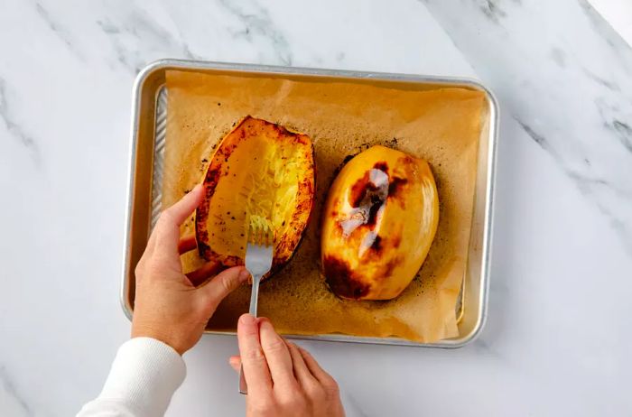 Scraping the roasted strands of spaghetti squash