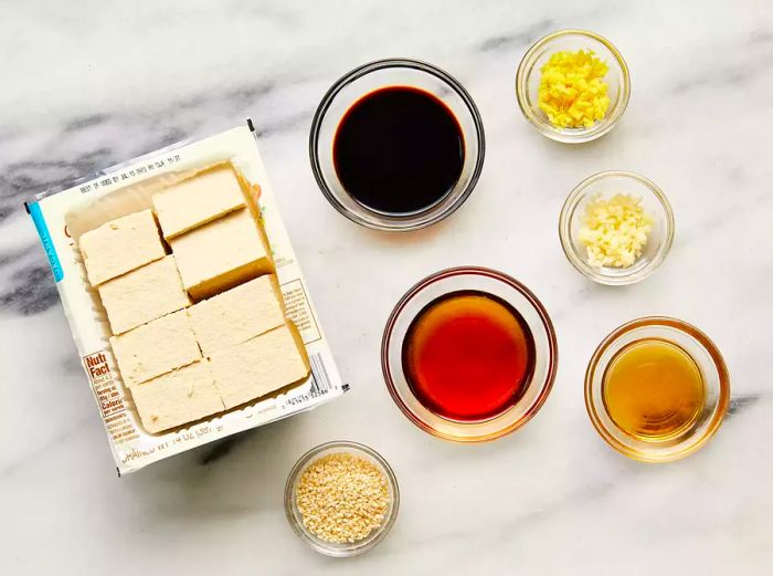 Ingredients for Baked Tofu arranged on a marble countertop