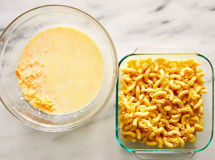 A top-down view of the cooked macaroni beside a bowl of creamy cheese sauce, ready to be combined for mac and cheese.