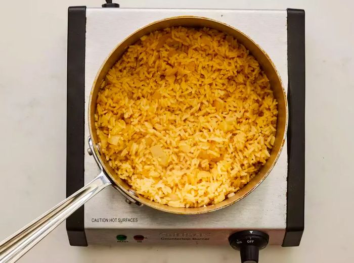 A pan of rice cooked with garlic and onions