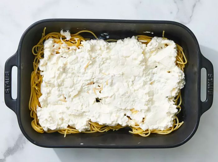 Cottage cheese, cream cheese, and sour cream blended together and spread over the noodles