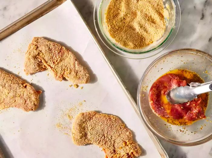 Each cutlet coated in both the egg mixture and bread crumbs.