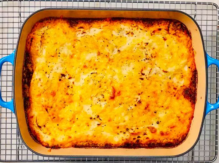 Golden-baked cottage pie cooling on a wire rack.