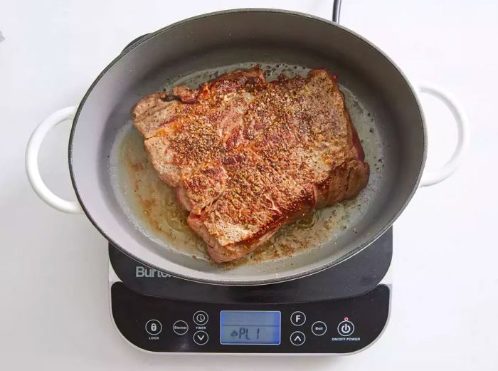 A large pot containing the browned chuck roast