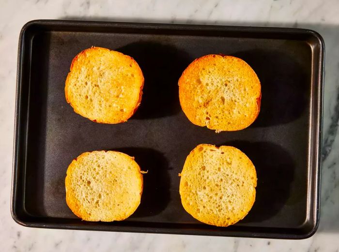 Toasted bread on the baking sheet.