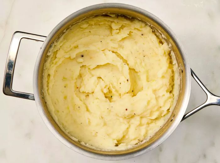 Smooth and creamy mashed potatoes in the pot.