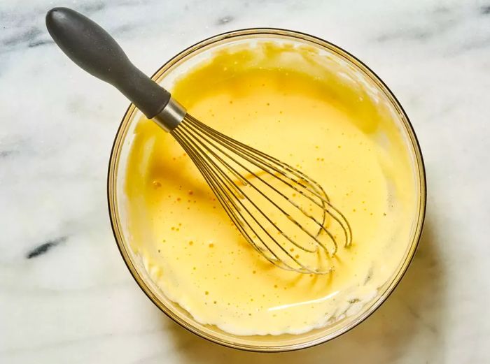 Egg whites whipped in a bowl until fluffy