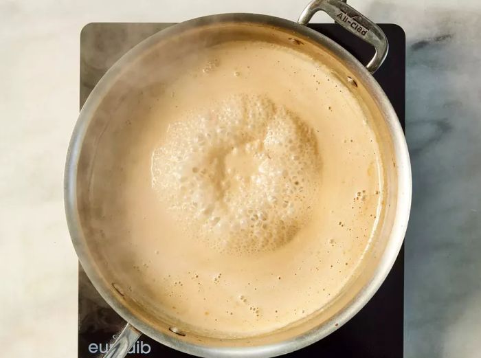 A pan of cream sauce gently simmering