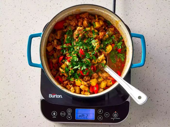 The dish is topped with a sprinkle of fresh parsley before serving.