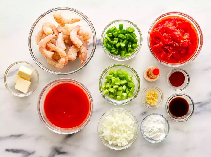 An overhead view of the measured ingredients ready for shrimp Creole.