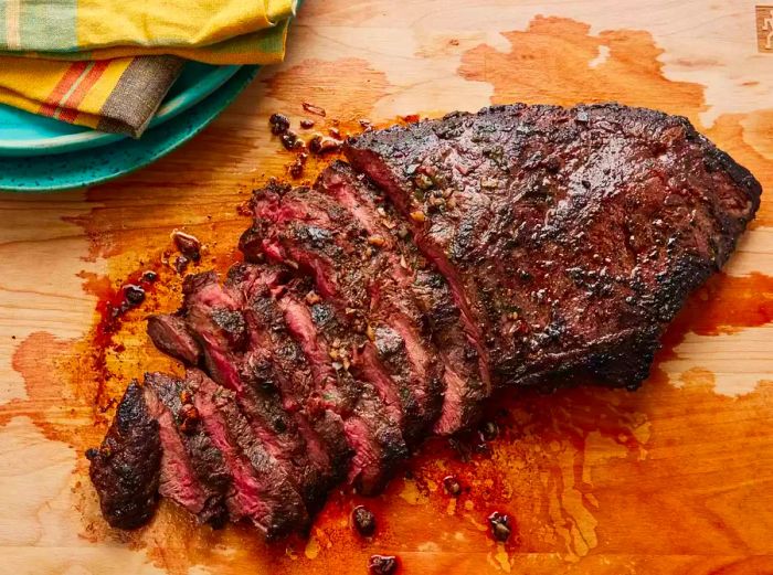 Overhead shot of sliced flat iron steak on a wooden board