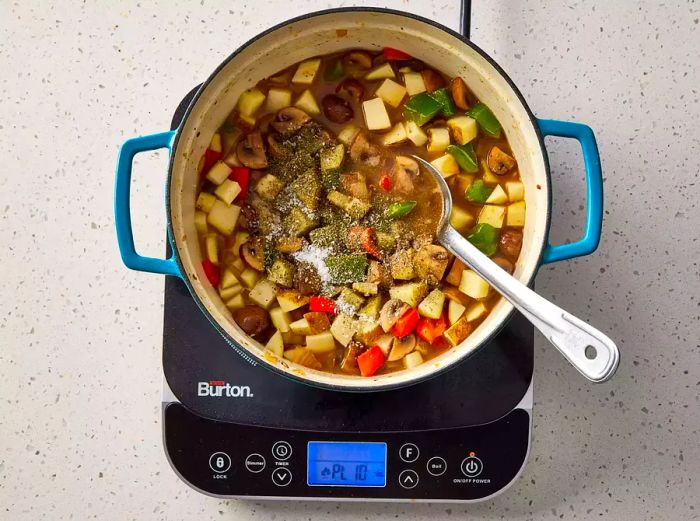 Potatoes, white wine, chicken broth, brine, Italian seasoning, and salt are mixed into the vegetables.