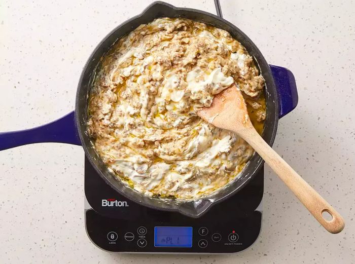 Sour cream added to the skillet, stirring until fully heated through.