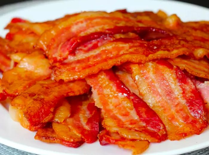 close-up shot of crispy bacon on a white plate