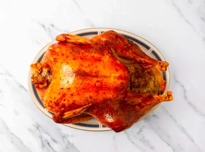 Roasted turkey resting on a serving platter.