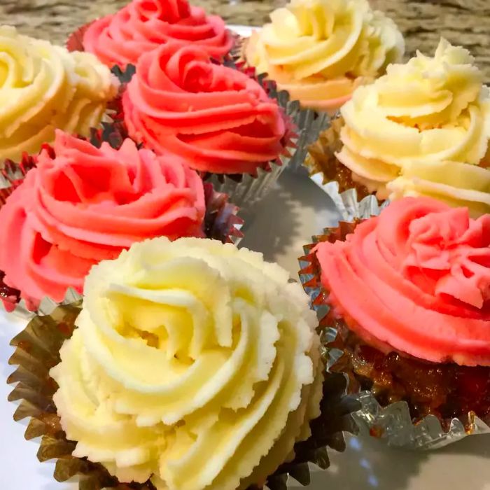 A close-up shot of Meatloaf Cupcakes topped with red and white mashed potatoes, arranged on a platter.