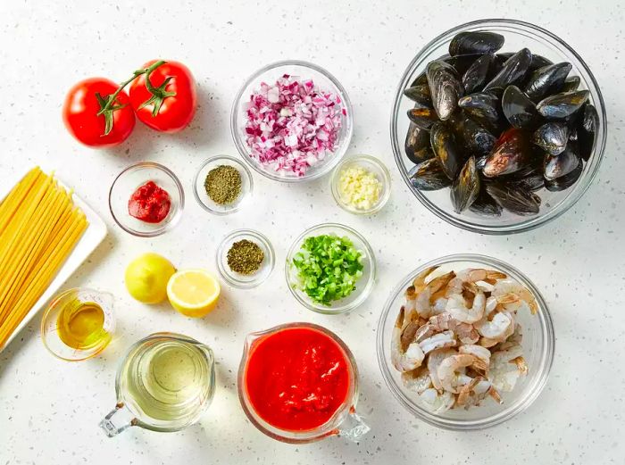 A bird's-eye view showcasing all the ingredients for Seafood Marinara Pasta