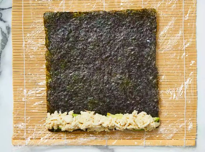 The crab mixture is layered over the avocado slices.