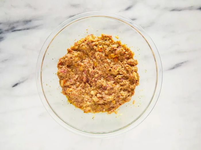 A top-down view of the meatball mixture in a bowl.